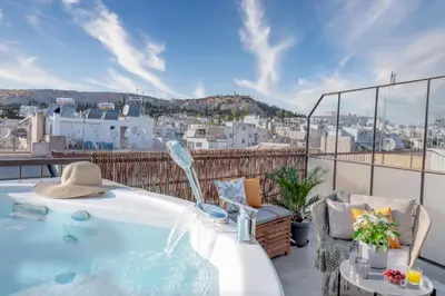 a hot tub on a balcony with a view of a city at TopFloor Getaway Balcony&Hot tub+Acropolis view in Athens