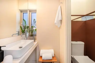 a bathroom with a sink and a toilet at TopFloor Getaway Balcony&Hot tub+Acropolis view in Athens