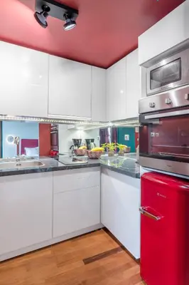 a kitchen with white cabinets and a red refrigerator at TopFloor Getaway Balcony&Hot tub+Acropolis view in Athens