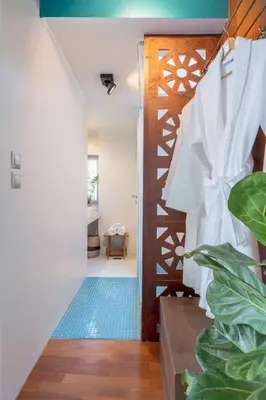 a hallway with a wooden door and a blue rug at TopFloor Getaway Balcony&Hot tub+Acropolis view in Athens