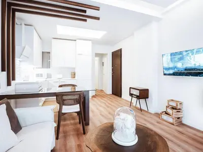 a living room with a table and a couch at Luxury Apartment in the Heart of the City - 1BR in Athens