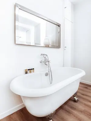 a white bath tub in a bathroom with a mirror at Luxury Apartment in the Heart of the City - 1BR in Athens