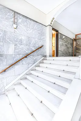 an empty staircase in a building with marble walls at Luxury Apartment in the Heart of the City - 1BR in Athens