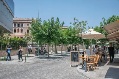 a group of people walking around a courtyard with tables and chairs at Luxury Apartment in the Heart of the City - 1BR in Athens
