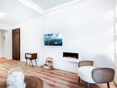 a living room with a couch and a fireplace at Luxury Apartment in the Heart of the City - 1BR in Athens