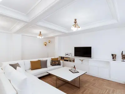 a white living room with a white couch and a table at Luxury 3BR Apartment in the Heart of the City in Athens