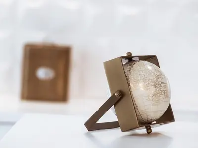 a globe on a tripod next to a box at Luxury 3BR Apartment in the Heart of the City in Athens