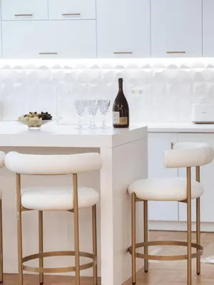 a kitchen with white cabinets and white bar stools at Luxury 3BR Apartment in the Heart of the City in Athens