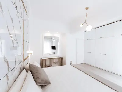 a white bedroom with a bed and a mirror at Luxury 3BR Apartment in the Heart of the City in Athens