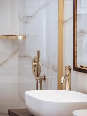 a bathroom with a white sink and a mirror at Luxury 3BR Apartment in the Heart of the City in Athens