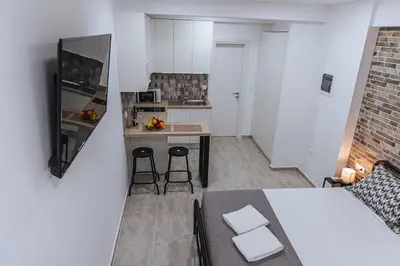 a small kitchen with a table and chairs in a room at Niovis Loft VIPGreece in Athens