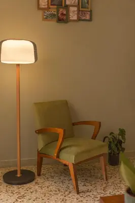 a lamp and a green chair next to a lampost at Acropolis View-Living Stone Amethyst in Athens