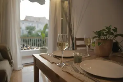 a table with two glasses of wine and a window at Acropolis View-Living Stone Amethyst in Athens