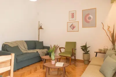 a living room with a green couch and chairs at Acropolis View-Living Stone Amethyst in Athens