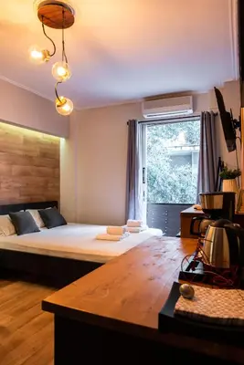 a bedroom with a large bed and a large window at Nueva Era Boutique in Athens