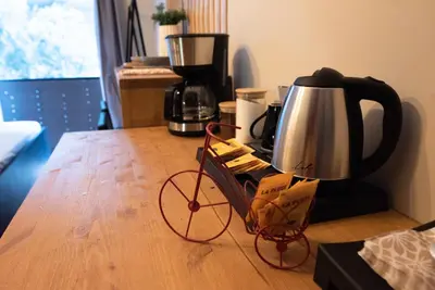 a bike cart sitting on a table with a coffee maker at Nueva Era Boutique in Athens