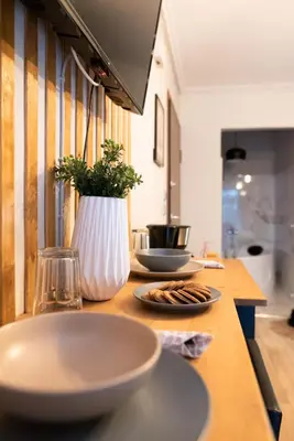 a table with plates of food and a vase on it at Nueva Era Boutique in Athens
