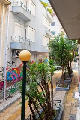 a street light in front of a building with graffiti at Nueva Era Boutique in Athens