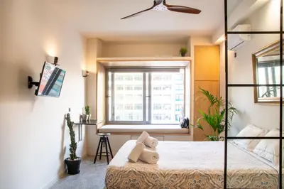 a bedroom with a bed with a teddy bear on it at Mosaics studio apt in the Central Market of Athens in Athens