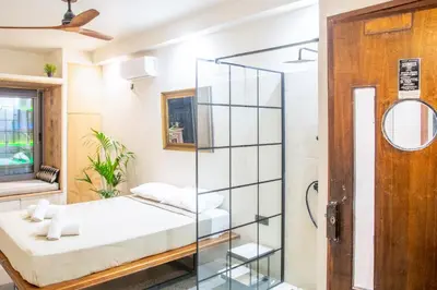 a room with a bed and a glass wall at Mosaics studio apt in the Central Market of Athens in Athens