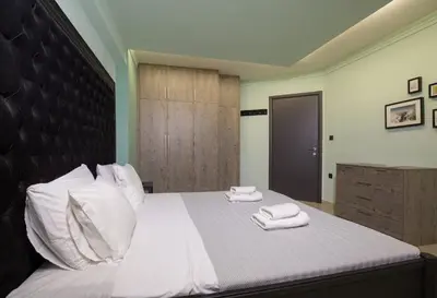a bedroom with a bed with two towels on it at Spacious Modern Apartments With Great Rooftop View in Athens