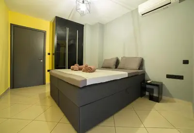 a bedroom with a large bed in a room at Spacious Modern Apartments With Great Rooftop View in Athens