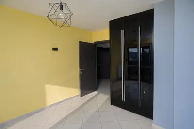 a room with a black cabinet and a hallway at Spacious Modern Apartments With Great Rooftop View in Athens