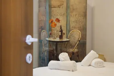 a room with a table and a bed with towels at Spacious Modern Apartments With Great Rooftop View in Athens