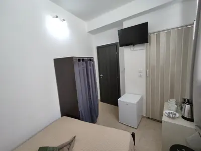 a small room with a bed and a bathroom at PURE URBAN METRO KATO PATISIA in Athens