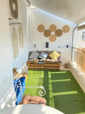 a living room with a couch and a green carpet at Lycabetus View Loft Downtown Kolonaki in Athens