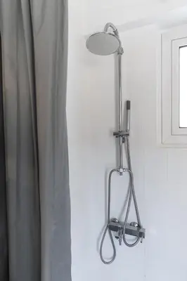 a light hanging from a wall next to a curtain at Lycabetus View Loft Downtown Kolonaki in Athens