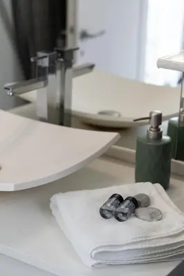 a pair of scissors sitting on a white towel at Lycabetus View Loft Downtown Kolonaki in Athens