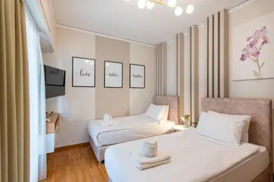 a hotel room with two beds and a chair at MEDLUXE LUXURY APARTMENT ! in Athens