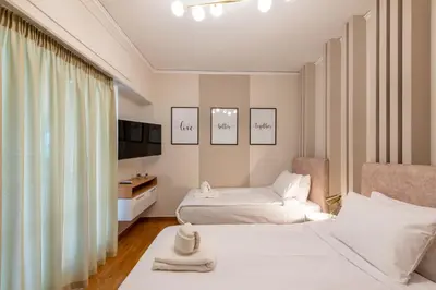 a hotel room with two beds and a television at MEDLUXE LUXURY APARTMENT ! in Athens