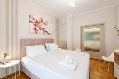 a bedroom with a white bed with two towels on it at MEDLUXE LUXURY APARTMENT ! in Athens