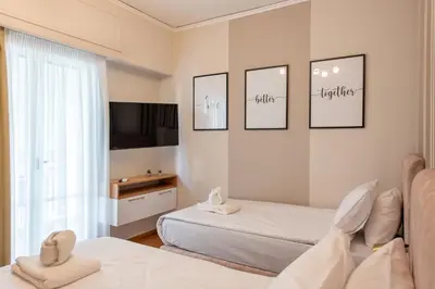 a hotel room with two beds and a television at MEDLUXE LUXURY APARTMENT ! in Athens