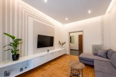 a living room with a couch and a tv at MEDLUXE LUXURY APARTMENT ! in Athens