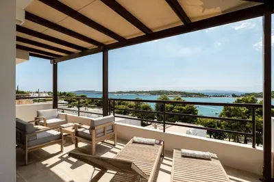 a balcony with chairs and a view of the ocean at Athens Riviera Bay View Suite By The Olon in Athens