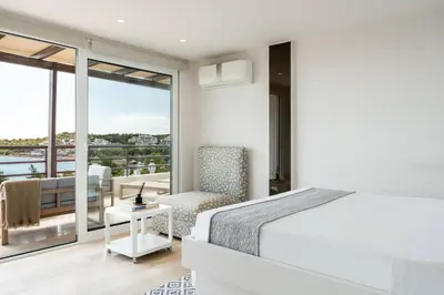 a bedroom with a bed and a balcony at Athens Riviera Bay View Suite By The Olon in Athens