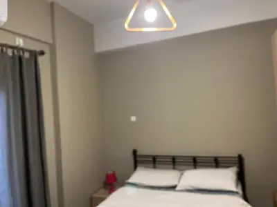 a bedroom with a bed with two pillows at Πάρκο Γουδή in Athens