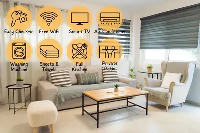 a living room with a couch and signs on the wall at Easy & Comfy Nights in Athens
