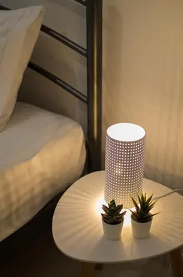 a table with two plants on it next to a bed at Easy & Comfy Nights in Athens