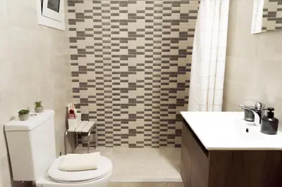 a bathroom with a toilet and a sink at Easy & Comfy Nights in Athens