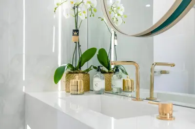 a bathroom counter with two faucets and a mirror at Divine Residence, a SeaView Retreat, By ThinkVilla in Piraeus