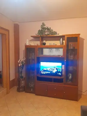 an entertainment center with a television in a living room at Cozy apartment in Piraeus