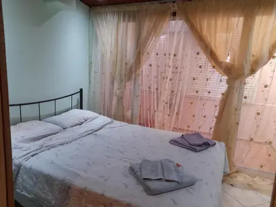 a bedroom with a bed with two towels on it at Cozy apartment in Piraeus