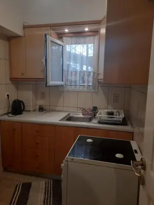 a kitchen with a sink and a counter top at Cozy apartment in Piraeus