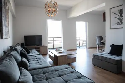a living room with a couch and a tv at Renovated apartment 5min from subway station 'Attiki' in Athens