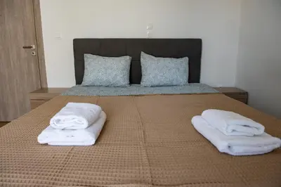 two towels on a bed with two pillows at Renovated apartment 5min from subway station 'Attiki' in Athens