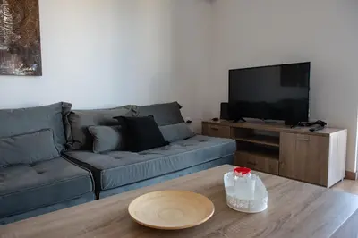 a living room with a couch and a table at Renovated apartment 5min from subway station 'Attiki' in Athens